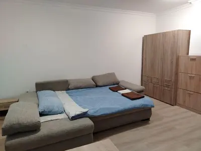a bedroom with a bed and a dresser at Apartments Sarafovo in Burgas City