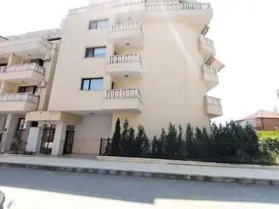 a white building with trees in front of it at Apartments Sarafovo in Burgas City