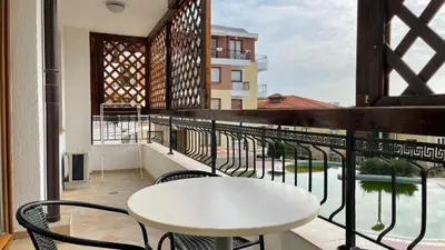 a balcony with a white table and chairs at GARDEN OF EDEN B3-2 Private One Bedroom Apartment in Sveti Vlas