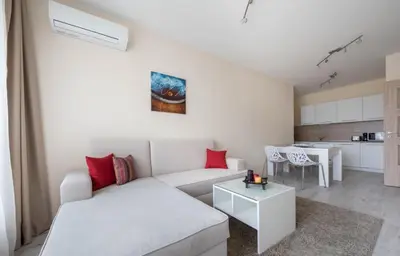 a living room with a white couch and a table at Stoyanov South Bay - Varna in Varna City