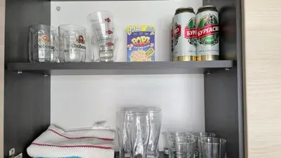 a shelf with cups and drinks on it at SUMMER BREEZE 406 Studio Sunny Beach in Sunny Beach