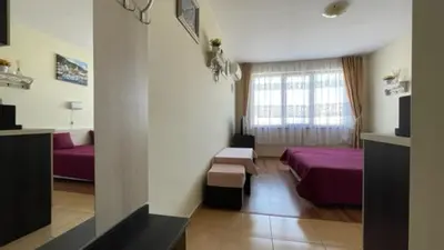 a hotel room with a bed and a window at SUMMER BREEZE 406 Studio Sunny Beach in Sunny Beach