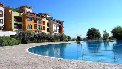 a swimming pool in front of some buildings at Аpartments Comfort -Marina Cape in Aheloy