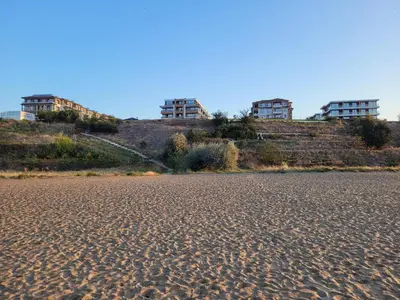 a beach with three buildings on top of a hill at Bayview B32 - Burgas Beach Resort 2 in Burgas City