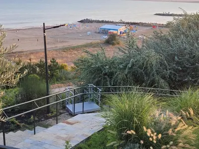 a staircase leading to a beach with a bench at Bayview B32 - Burgas Beach Resort 2 in Burgas City
