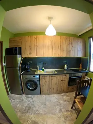 a kitchen with a sink and a refrigerator at Sunset Yavorov Pomorie in Pomorie