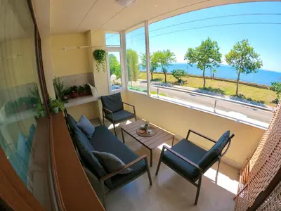 a living room with a view of the ocean at Sunset Yavorov Pomorie in Pomorie
