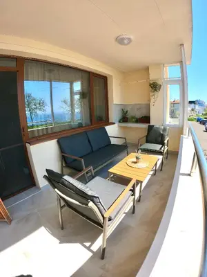 a living room with a couch and chairs and a table at Sunset Yavorov Pomorie in Pomorie