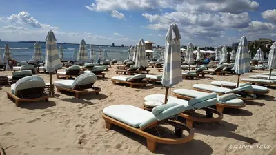 a group of lounge chairs and umbrellas on a beach at Seaside Apartment with 2 Bedrooms for up to 5 Guests in Sunny Beach