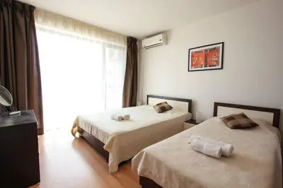 a hotel room with two beds and a window at Seaside Apartment with 2 Bedrooms for up to 5 Guests in Sunny Beach