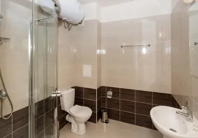 a bathroom with a toilet and a sink and a shower at Seaside Apartment with 2 Bedrooms for up to 5 Guests in Sunny Beach