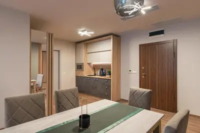 a dining room with a table and chairs at Green Luxury Apartments in Burgas City