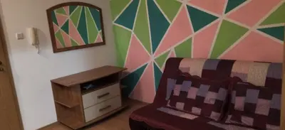 a bedroom with a couch and a colorful wall at Apartment Jasna Hotel Oazis in Ravda
