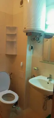 a bathroom with a toilet and a sink at Apartment Jasna Hotel Oazis in Ravda