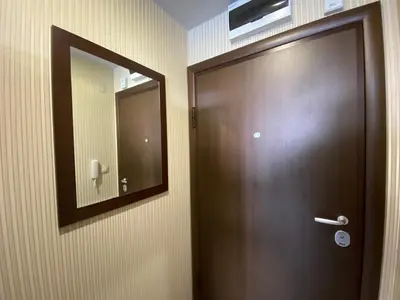 a wooden door with a mirror on a wall at PARADISO B 210 Private Sea View Studio NESSEBAR in Nesebar