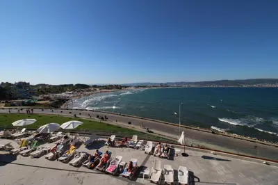 a group of people sitting in chairs next to a beach at PARADISO B 210 Private Sea View Studio NESSEBAR in Nesebar