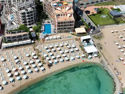 an aerial view of a beach with umbrellas at Beachfront Apartments by Marty's in Sunny Beach
