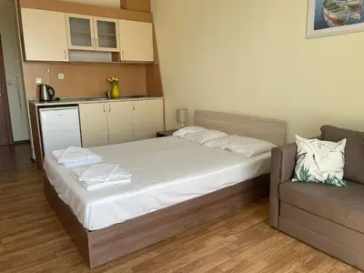 a small bedroom with a bed and a couch at Rutland SP apartments in Ravda