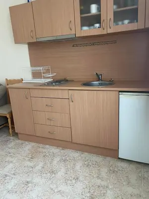 a kitchen with a sink and a laptop on the counter at Rutland SP apartments in Ravda