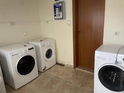 a laundry room with a washing machine and a washer at Rutland SP apartments in Ravda