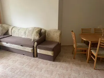 a living room with a couch and a table at Rutland SP apartments in Ravda