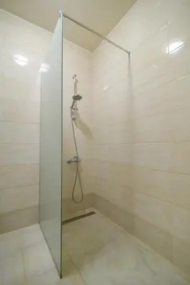 a bathroom with a shower with a glass door at МareliS Luxe Port Apartment in Varna City