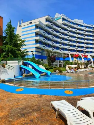 a swimming pool with a slide in front of a building at TRAKIA PLAZA Apartments in Sunny Beach