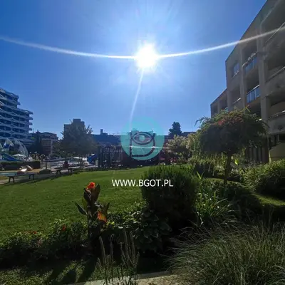 a sign in a park in front of a building at TRAKIA PLAZA Apartments in Sunny Beach
