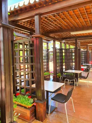 a wooden pergola with tables and chairs on a patio at TRAKIA PLAZA Apartments in Sunny Beach