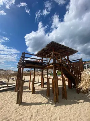 a wooden shelter on a beach with a sky at Manastira-2 (A-3) in Sveti Vlas