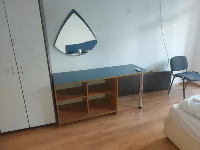 a desk with a mirror and a chair in a room at Studio and 1bedroom apartment Burgas - Economy in Burgas City
