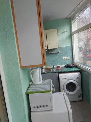 a small kitchen with a washing machine and a washer at Studio and 1bedroom apartment Burgas - Economy in Burgas City