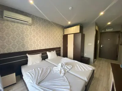 a bedroom with a bed with a bow on it at PARADISO B 209 Private Sea View Studio NESSEBAR in Nesebar