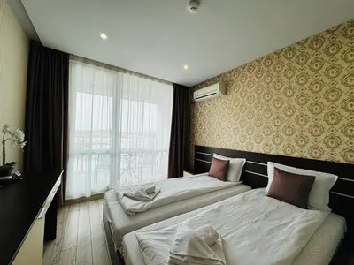 a hotel room with two beds and a window at PARADISO B 208 Private Sea View Studio NESSEBAR in Nesebar