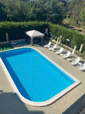an overhead view of a swimming pool with chairs and a tent at Pomorie residence 2-bedroom apartment 300m to the beach in Pomorie