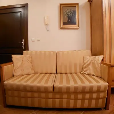 a couch sitting in a living room at Helios 350m from the beach in Sveti Vlas