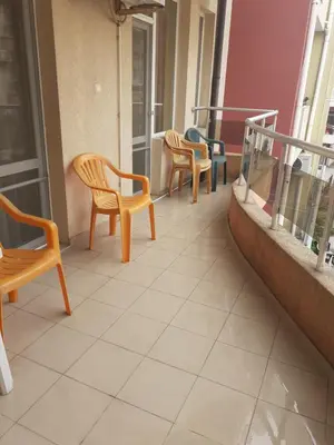 three chairs sitting on a balcony of a building at Apartments Sea Sounds in Pomorie
