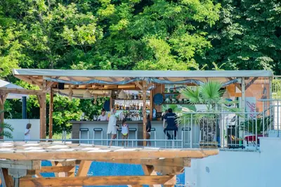 a bar with a wooden table next to a pool at White Cliffs, Byala in Byala