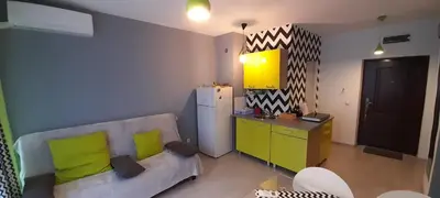 a living room with a couch and a yellow cabinet at Spokojne wakacje w Bułgarii in Sunny Beach