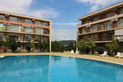 a large swimming pool in front of a building at Holiday-Orchid Menada Apartments in Sunny Beach