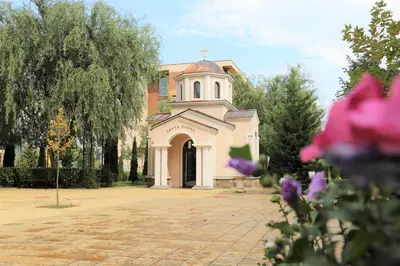 a small church with a cross on top of it at Holiday-Orchid Menada Apartments in Sunny Beach