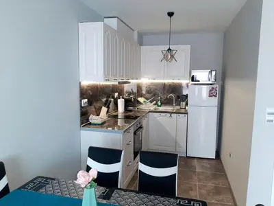 a kitchen with white cabinets and a white refrigerator at BBR26- Sea View First Line Apartment Sarafovo in Burgas City