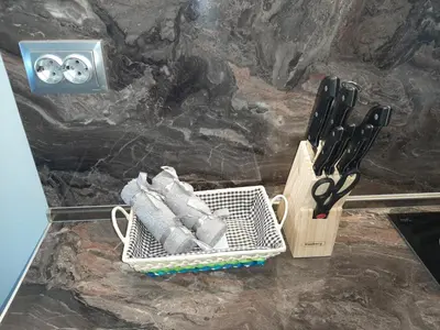 a counter with a basket of knives and a pair of scissors at BBR26- Sea View First Line Apartment Sarafovo in Burgas City