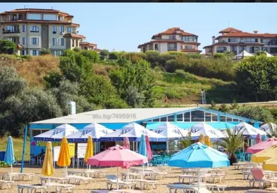 a group of umbrellas and chairs on a beach at BBR26- Sea View First Line Apartment Sarafovo in Burgas City