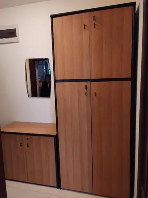 a large wooden cabinet in a room with a mirror at Уютно и просторно студио in Ravda