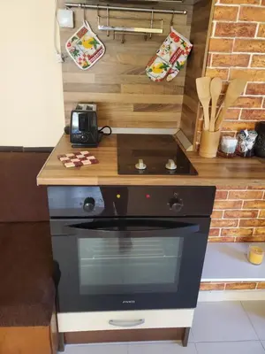 a kitchen with a stove and a counter top at Уютно и просторно студио in Ravda
