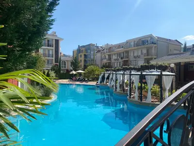 a swimming pool with blue water and some buildings at MESSEMBRIA B504 Studio Sunny Beach in Sunny Beach