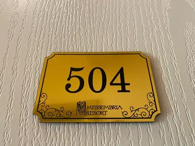 a yellow sign hanging on a wall at MESSEMBRIA B504 Studio Sunny Beach in Sunny Beach