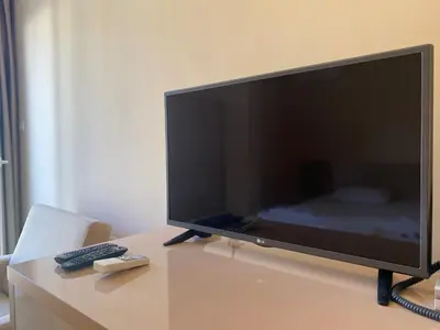 a large flat screen tv sitting on a table at MESSEMBRIA B504 Studio Sunny Beach in Sunny Beach