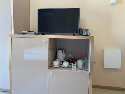 a tv sitting on top of a cabinet with a television at MESSEMBRIA B504 Studio Sunny Beach in Sunny Beach